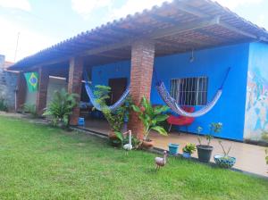 a blue house with a lawn in front of it at Casa Azul in Barreirinhas