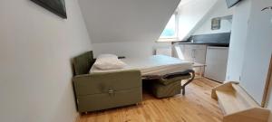 a small room with a bed and a table at La Chouette in Gérardmer