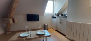a room with a table with two wine glasses on it at La Chouette in Gérardmer +13 photos