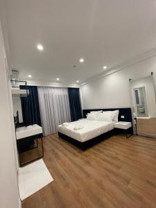 a bedroom with a bed and a sink in it at SEA & LAKE VIEW VILLA in (( Kalive Gjoka ))