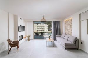 a living room with a couch and a table at Luxury Villas Ammos in Style in Matala