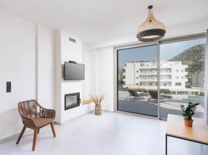 a living room with a view of a building at Luxury Villas Ammos in Style in Matala