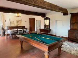 a living room with a pool table in it at Le Champ Du Possible in Uxeau