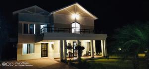 a house with a light on top of it at night at Celestial Resorts, Retreat in Nature in Phanda