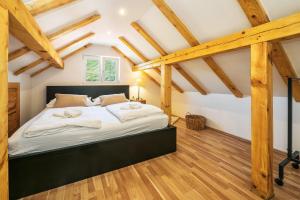 a bedroom with a large bed with wooden beams at Stone Garden Villa, Heated Pool & Outdoor Cinema in Trilj +38 photos