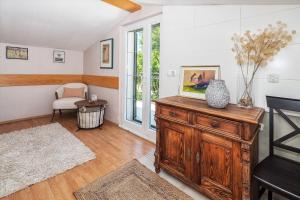 a living room with a wooden dresser and a window at Stone Garden Villa, Heated Pool & Outdoor Cinema in Trilj