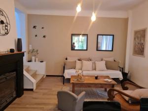 a living room with a couch and a table at Maison Gemenos in Gémenos