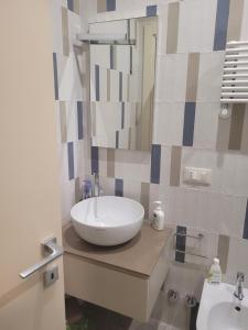 a bathroom with a white sink and a mirror at Cala Paradiso in Monopoli +50 photos