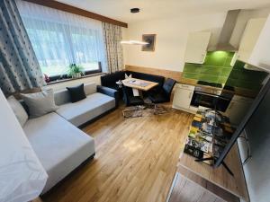 a living room with a couch and a table at ALPTyrol in Rifenal