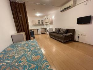 A television and/or entertainment centre at Menada Grand Kamelia Apartments