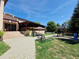 a bike parked in the grass in front of a building at Topolský pivovar, restaurace a penzion in Topolná