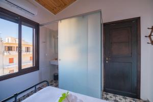 a room with a door and a window and a table at Marthas DeLight Rooms in Chania
