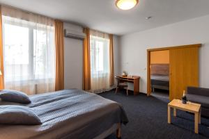 Postel nebo postele na pokoji v ubytování Hotel Museum