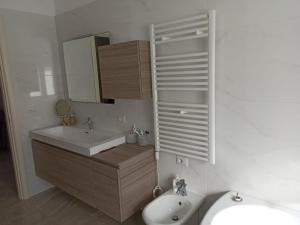 a bathroom with a sink and a mirror and a toilet at Residenza Tafuri in Salerno