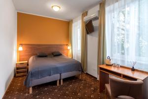 Postel nebo postele na pokoji v ubytování Hotel Museum