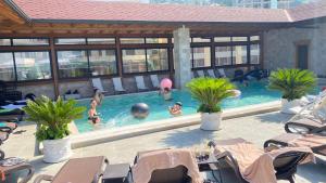 a group of people in a swimming pool at Rooms Panorama in Krujë