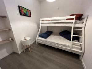 a room with two bunk beds and a table at Relax Sax Appartment in Dinant