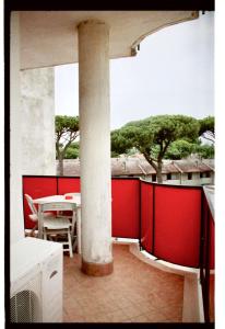 a room with a table and a pillar in a building at Tropicana Residence in Lido degli Estensi