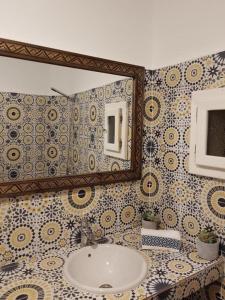 a bathroom with a sink and a mirror at Dar Surf in Taghazout +37 photos