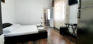 a bedroom with a bed and a table in it at Casa Eduard in Eforie Sud