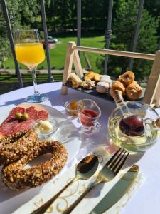 a table topped with food and a glass of orange juice at Oasis Titova vila in Palisat