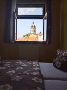 a bedroom with a window with a view of a building at Hotel Jaro in Mělník
