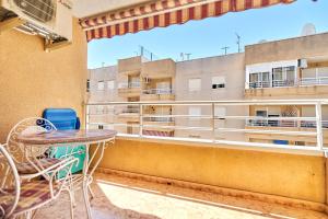 a balcony with a table and chairs and a building at Espanhouse David 2 bedroom apartment Torrevieja with pool in Torrevieja