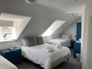 a bedroom with two beds and a attic at Norfolk Hotel in Weymouth