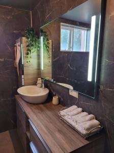 W łazience znajduje się umywalka i lustro. w obiekcie The old house w mieście Selfoss