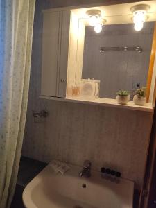 a bathroom with a sink and a mirror at La Casa De Vacation in Lafkos