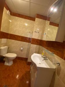 a bathroom with a toilet and a sink and a mirror at Nessebar Fort Club Apartment 226 in Sunny Beach +20 photos