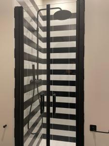 a glass door with a black and white railing at Ritorno alle origini Suites in Milan