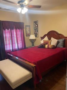 a bedroom with a bed with a red comforter at A Peaceful Hidden Treasure in Oxford GA in Conyers