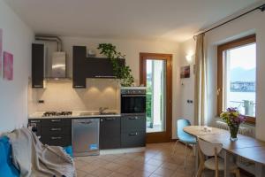 a kitchen with a table and a dining room at La Casetta Varenna in Varenna