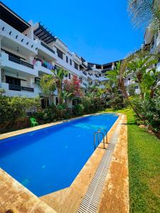 a swimming pool in front of a building at Visit Oued Laou - Jawhara in Oued Laou