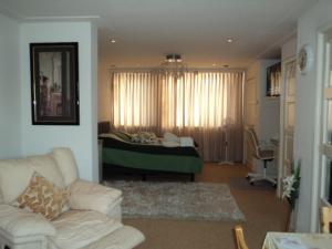 a living room with a couch and a bed at B&B Bosscheweg in Tilburg