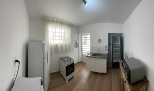 a kitchen with a refrigerator and a sink at Jardins Village Hostel - Jardim Paulista in São Paulo