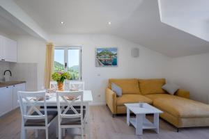 a living room with a couch and a table at Apartments Mili in Ston