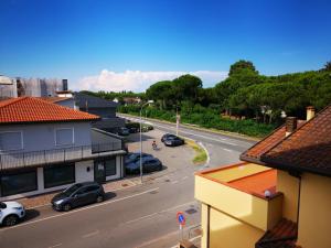 a view of a street with cars parked on the road at Rosolina (Paese) Apartment in Rosolina