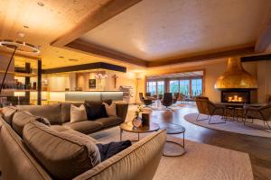 a living room with a couch and a fireplace at Das Kaltenbach - ApartHotel in Kaltenbach