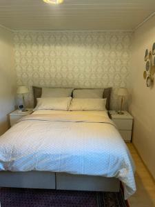 a bedroom with a large bed with two night stands at Ferienwohnung Lea in Bad Karlshafen