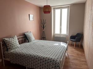 a bedroom with a bed and a window and a chair at Domaine clos et arboré de 3 ha avec deux maisons in Lamothe-Montravel +21 photos
