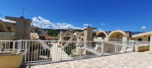 a white fence in front of a group of houses at Appartamento Marimar in Vasto