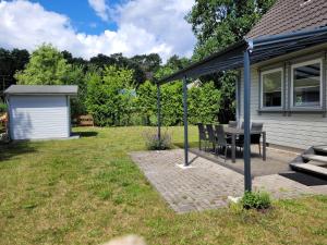 a patio with a table and a house at Ferienwohnung Ostseebad Karlshagen in Karlshagen