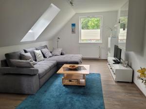 a living room with a couch and a table at Ferienwohnung Ostseebad Karlshagen in Karlshagen