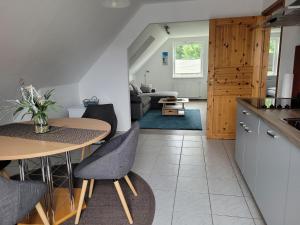 a kitchen and living room with a table and chairs at Ferienwohnung Ostseebad Karlshagen in Karlshagen