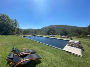 a swimming pool in the middle of a grass field at 1832 La Rabassière in Malaucène +35 photos