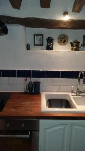 a kitchen with a sink and a wooden counter top at The Granary in Hardwick