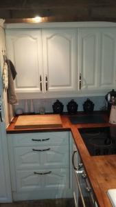 a kitchen with white cabinets and a stove at The Granary in Hardwick