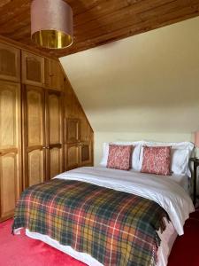 A bed or beds in a room at Machair House